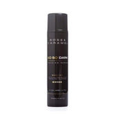 Black bottle branded Rose & Caramel so so dark tanning serum on a white background.