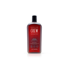 Bottle of American Crew Detox Shampoo with a dark liquid visible through the transparent bottle, labeled for men's haircare.