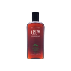 Brown shampoo bottle with green and white writing on a white background.