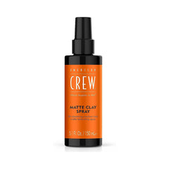 A black spray bottle with orange label on with white writing on a white background.