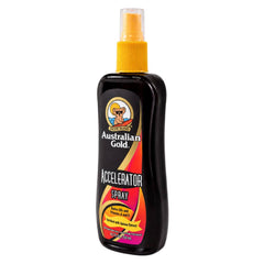 A bottle of Australian Gold Accelerator Spray with a black body, yellow spray nozzle, and a colorful label featuring red, orange, and yellow graphics.