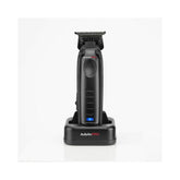 Compact Trimmer in its charging stand on a white background.