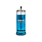 Classic glass Barbicide jar filled with translucent blue disinfectant solution, featuring its recognizable white logo.
