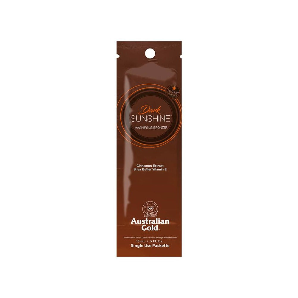 A 15ml sachet of Australian Gold Dark Sunshine tanning lotion with a brownish-gold color scheme and product information on the front.