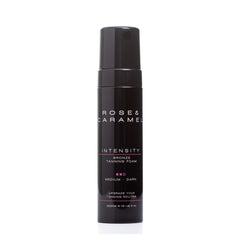 Black bottle branded Rose & Caramel. Bronze tanning foam in shade medium/dark with a white background. 