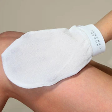 White glove being used on a person's arm with a neutral background