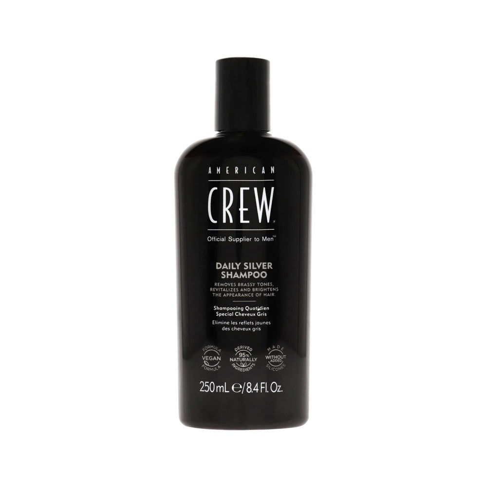 A black bottle of American Crew Daily Silver Shampoo with white and silver text detailing the product name and description.