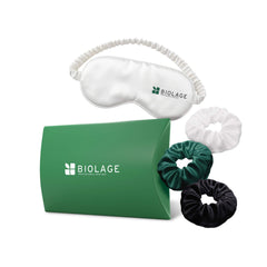 A green pouch next to three different scrunchies and a white sleep mask. 