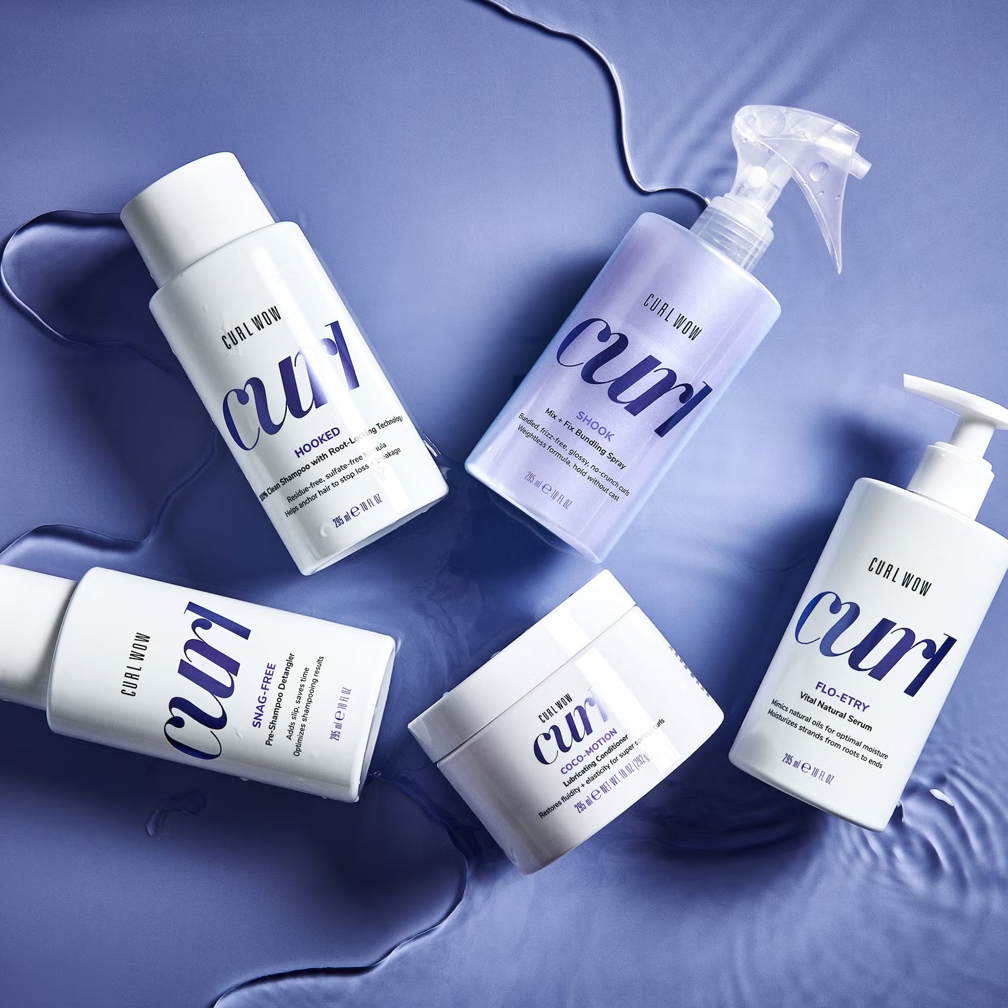 Collection of Curl Wow hair care products on a blue background