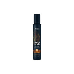The bottle features the white Indola logo at the top, followed vertically by the product name "color style MOUSSE" written in stylized fonts. A rectangular image swatch on the front label displays a glossy texture of wavy hair, indicating the product's shade. The bottom text specifies the bottle size as 200ml.
