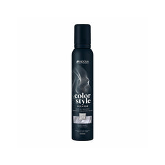 The bottle features the white Indola logo at the top, followed vertically by the product name "color style MOUSSE" written in stylized fonts. A rectangular image swatch on the front label displays a glossy texture of wavy hair, indicating the product's shade. The bottom text specifies the bottle size as 200ml.
