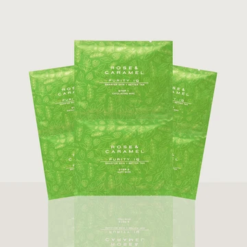 Three green Rose & Caramel Purity Q soft gels in pouches, arranged in a fan-like composition on a light gray background with a soft reflection below.