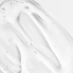 Close-up of a smooth, grayish-white surface with subtle texture and small bubbles.