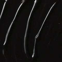 A close-up of glossy black material with several curved, reflective streaks running diagonally across the frame.