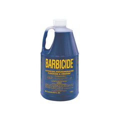 A blue bottle of Barbicide Solution with a white cap. The label is yellow with text and branding.